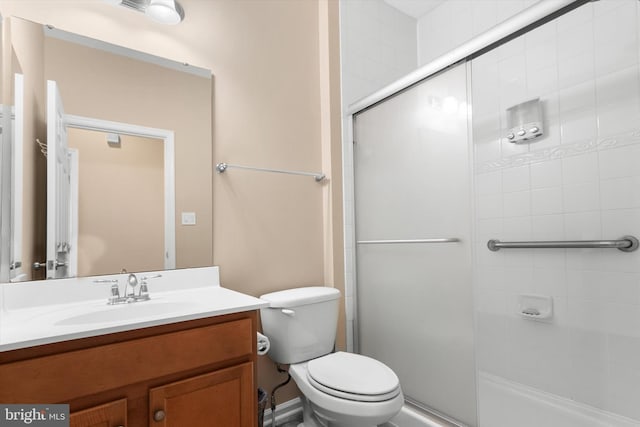 full bath featuring vanity, an enclosed shower, and toilet