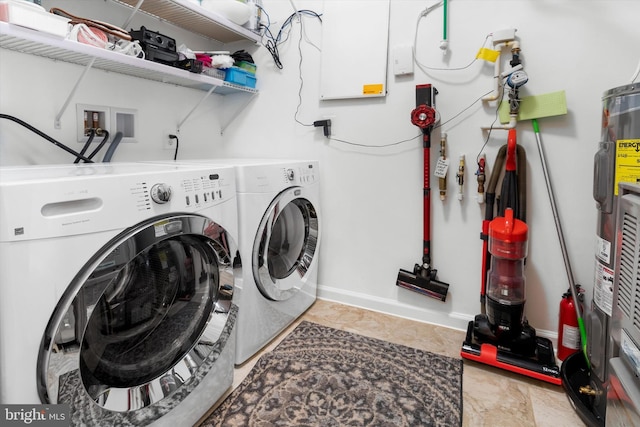 laundry room featuring baseboards, washer and clothes dryer, and laundry area