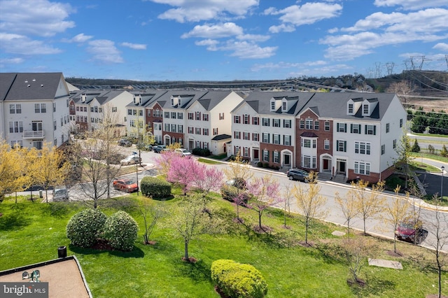 birds eye view of property with a residential view