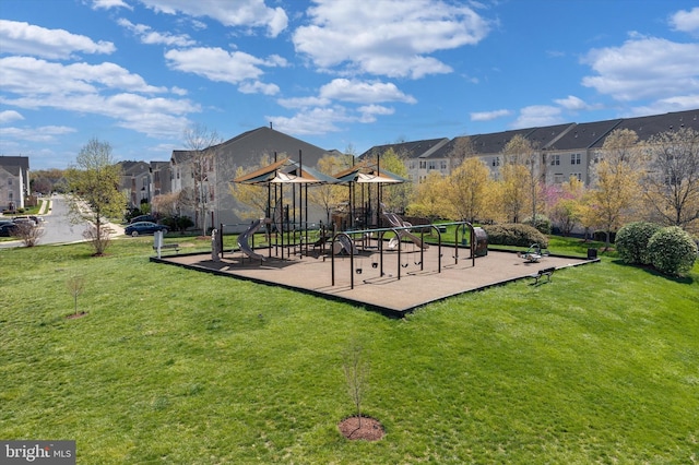communal playground featuring a residential view and a lawn