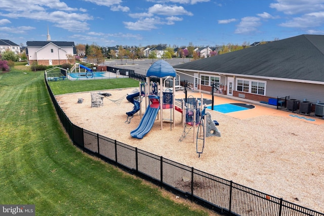community playground with fence, a patio, a yard, and cooling unit