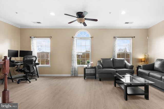 interior space featuring light wood-type flooring, visible vents, ornamental molding, and ceiling fan