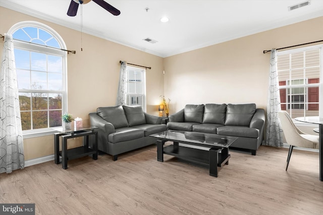 living room featuring visible vents, a ceiling fan, and ornamental molding