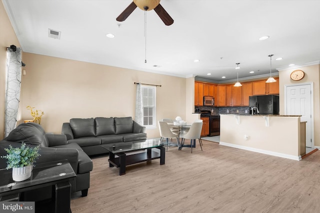 living room featuring recessed lighting, light wood-type flooring, a ceiling fan, and ornamental molding
