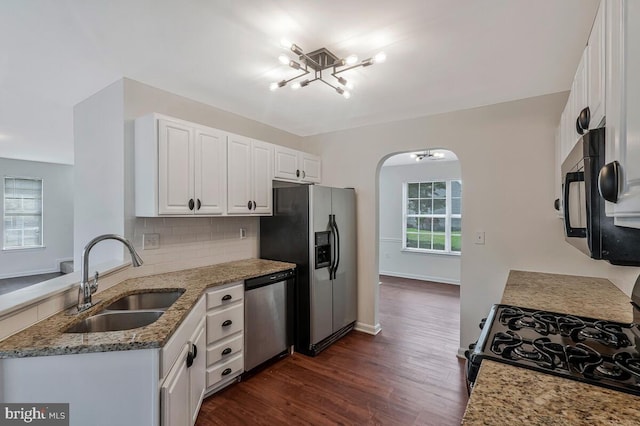 11620 Myrtle Oak Ct, Waldorf, MD 20601 - kitchen featuring a sink, stainless steel appliances, a chandelier, arched walkways, and light stone countertops