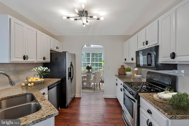 11620 Myrtle Oak Ct, Waldorf, MD 20601 - kitchen with stainless steel appliances, a sink, a chandelier, dark wood-style flooring, and arched walkways