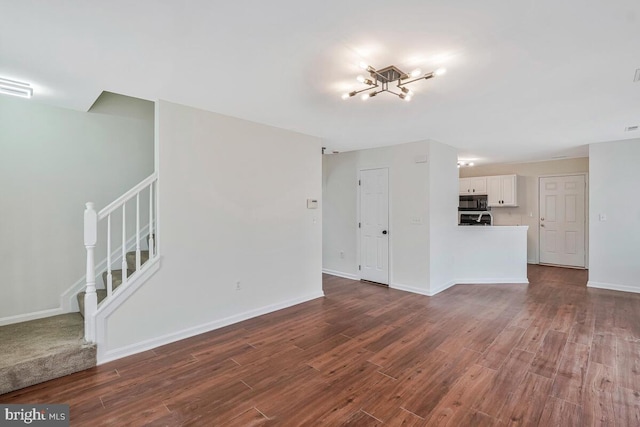 11620 Myrtle Oak Ct, Waldorf, MD 20601 - unfurnished living room with a chandelier, stairway, dark wood finished floors, and baseboards