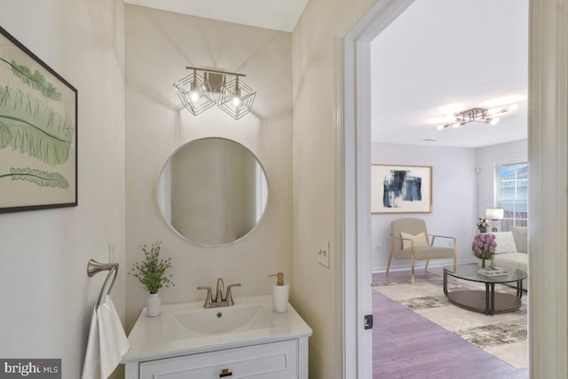 11620 Myrtle Oak Ct, Waldorf, MD 20601 - bathroom featuring a chandelier, vanity, wood finished floors, and baseboards