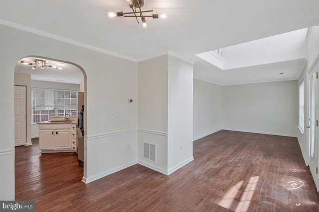 11620 Myrtle Oak Ct, Waldorf, MD 20601 - empty room featuring a chandelier, arched walkways, dark wood-type flooring, crown molding, and healthy amount of natural light