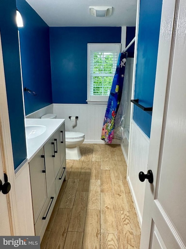 175 Barracuda Rd, Manahawkin, NJ 08050 - bathroom featuring a wainscoted wall, wood finished floors, toilet, vanity, and curtained shower