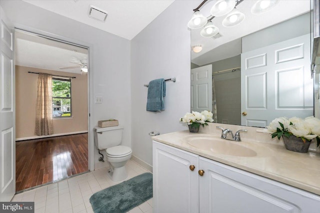 bathroom with visible vents, baseboards, toilet, tile patterned floors, and vanity