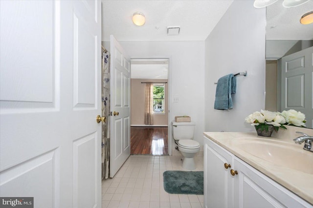 full bath featuring tile patterned floors, toilet, and vanity