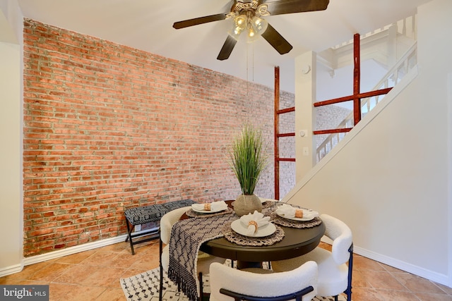 806 W 35th St, Baltimore, MD 21211 - dining area with stairway, brick wall, baseboards, and a ceiling fan
