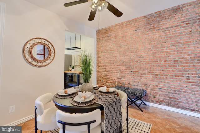 806 W 35th St, Baltimore, MD 21211 - dining space featuring brick wall, baseboards, tile patterned flooring, and ceiling fan
