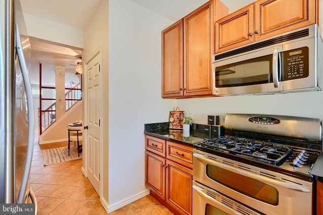 806 W 35th St, Baltimore, MD 21211 - kitchen featuring light tile patterned floors, stainless steel appliances, baseboards, and ceiling fan