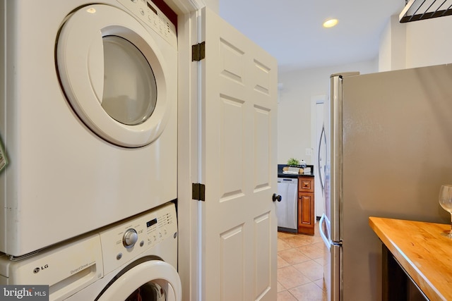 806 W 35th St, Baltimore, MD 21211 - laundry room featuring stacked washer and dryer, recessed lighting, laundry area, and light tile patterned floors