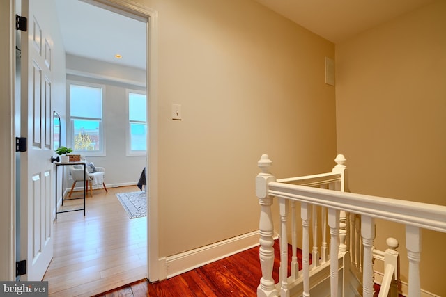 806 W 35th St, Baltimore, MD 21211 - hall featuring baseboards, wood finished floors, and an upstairs landing