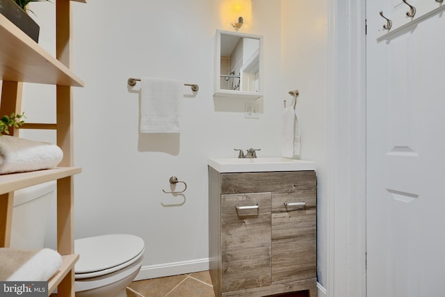 806 W 35th St, Baltimore, MD 21211 - bathroom with baseboards, tile patterned flooring, vanity, and toilet