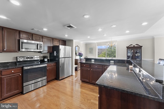 1515 S Arlington Ridge Rd Unit 402, Arlington, VA 22202 - kitchen with visible vents, ornamental molding, light wood-style floors, and stainless steel appliances