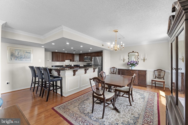1515 S Arlington Ridge Rd Unit 402, Arlington, VA 22202 - dining area with a textured ceiling, a chandelier, ornamental molding, and light wood-style floors