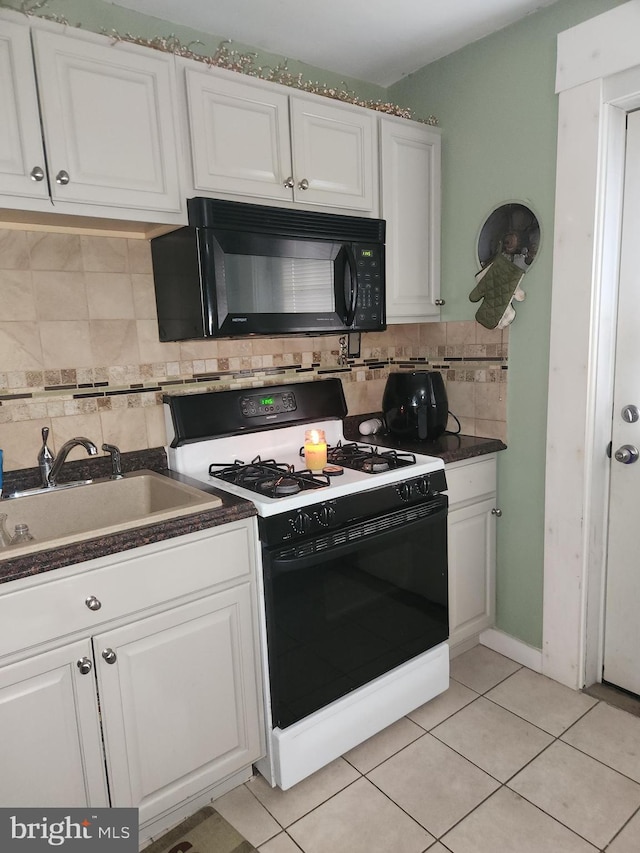 2027 Anchor St, Philadelphia, PA 19124 - kitchen with a sink, range with gas cooktop, white cabinets, and black microwave