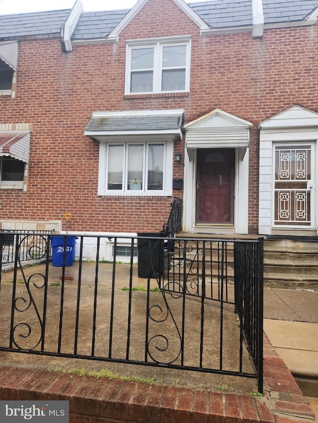 2027 Anchor St, Philadelphia, PA 19124 - view of front of property with brick siding, a high end roof, and a fenced front yard