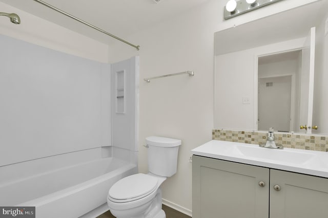 full bathroom with vanity, toilet, backsplash, baseboards, and  shower combination