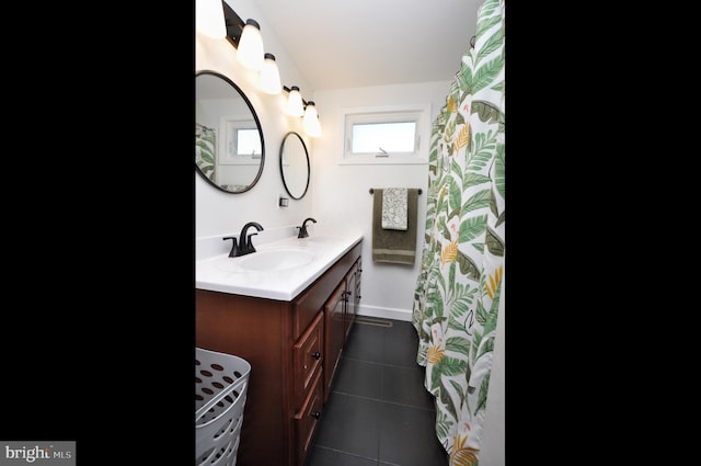 full bathroom with tile patterned floors and vanity