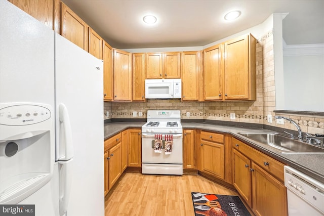701 Fallsgrove Dr Unit 314, Rockville, MD 20850 - kitchen featuring white appliances, light wood finished floors, dark countertops, tasteful backsplash, and crown molding