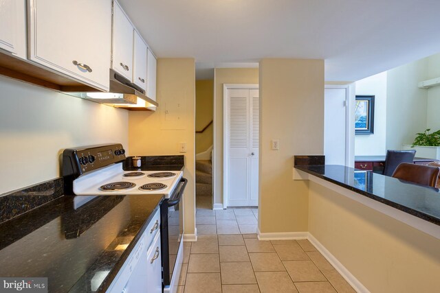 312 Severn Ave Unit W 401, Annapolis, MD 21403 - kitchen with electric range, white cabinetry, light tile patterned floors, under cabinet range hood, and dark stone countertops