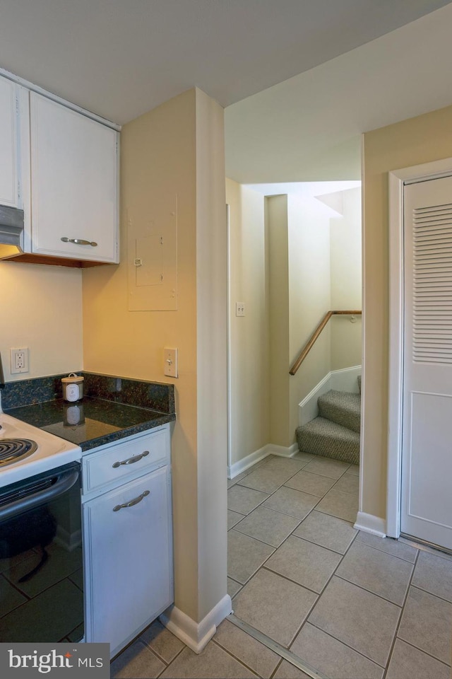 312 Severn Ave Unit W 401, Annapolis, MD 21403 - kitchen featuring white electric stove, white cabinetry, light tile patterned flooring, and dark stone countertops