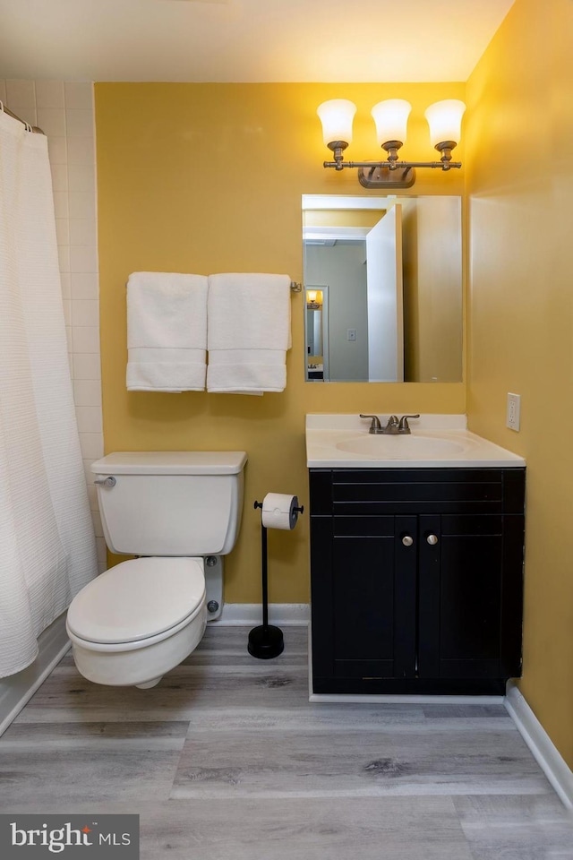 312 Severn Ave Unit W 401, Annapolis, MD 21403 - bathroom featuring vanity, wood finished floors, and curtained shower