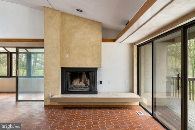 390 S Bryn Mawr Ave, Bryn Mawr, PA 19010 - unfurnished living room featuring visible vents, plenty of natural light, lofted ceiling, and a fireplace