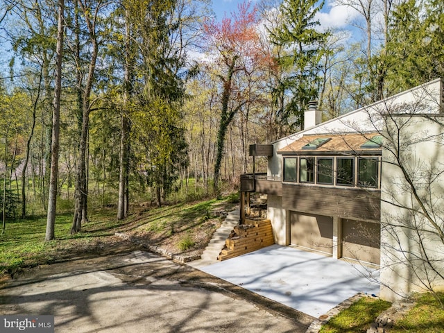 390 S Bryn Mawr Ave, Bryn Mawr, PA 19010 - view of patio featuring an attached garage and concrete driveway