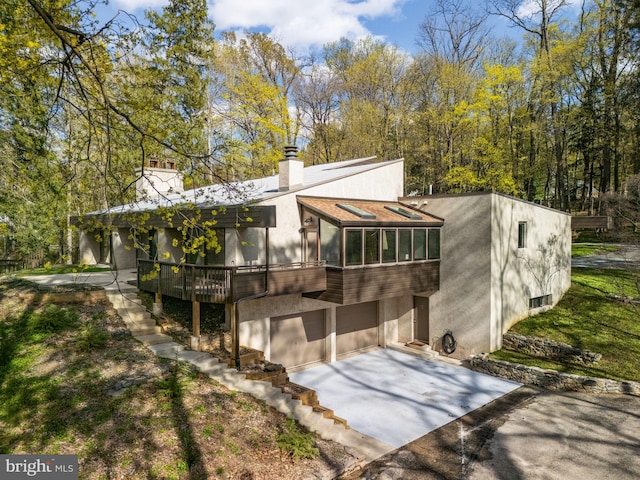 390 S Bryn Mawr Ave, Bryn Mawr, PA 19010 - exterior space with a chimney, an attached garage, and concrete driveway
