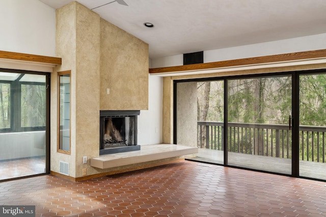 390 S Bryn Mawr Ave, Bryn Mawr, PA 19010 - unfurnished living room with tile patterned flooring, a fireplace with raised hearth, and visible vents