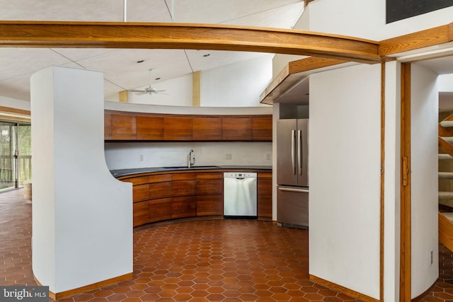 390 S Bryn Mawr Ave, Bryn Mawr, PA 19010 - kitchen featuring brown cabinetry, dark countertops, vaulted ceiling, and stainless steel appliances