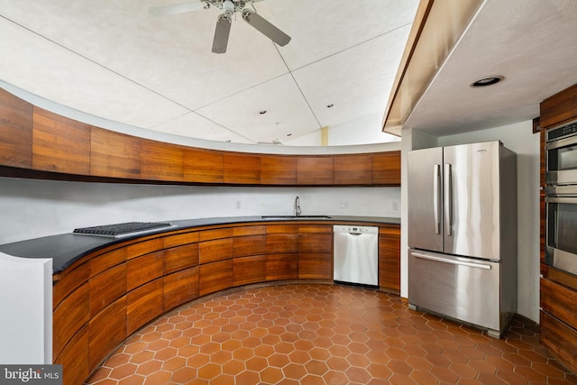 390 S Bryn Mawr Ave, Bryn Mawr, PA 19010 - kitchen featuring stainless steel appliances, brown cabinets, a sink, and dark countertops