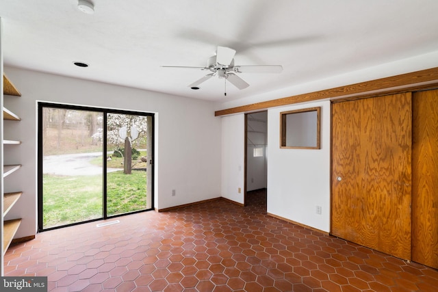 390 S Bryn Mawr Ave, Bryn Mawr, PA 19010 - empty room with a wealth of natural light, baseboards, a ceiling fan, and dark tile patterned flooring