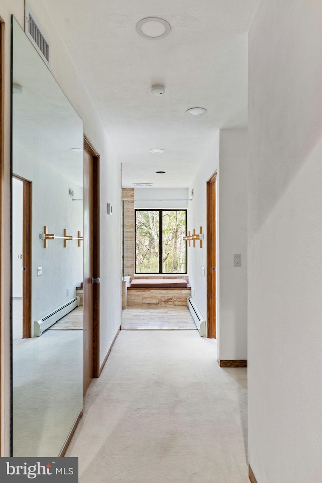 390 S Bryn Mawr Ave, Bryn Mawr, PA 19010 - hall with carpet, visible vents, a baseboard heating unit, and baseboards