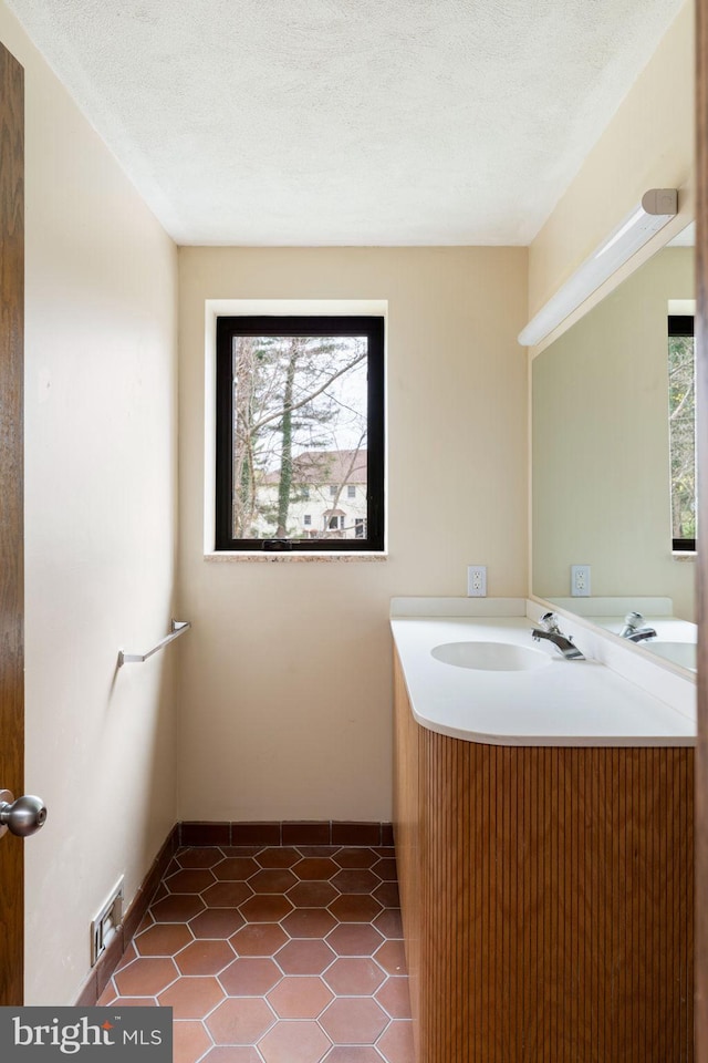 390 S Bryn Mawr Ave, Bryn Mawr, PA 19010 - bathroom with a textured ceiling, vanity, visible vents, tile patterned floors, and baseboards