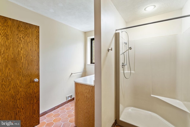 390 S Bryn Mawr Ave, Bryn Mawr, PA 19010 - bathroom featuring a textured ceiling, vanity, tile patterned flooring, and walk in shower