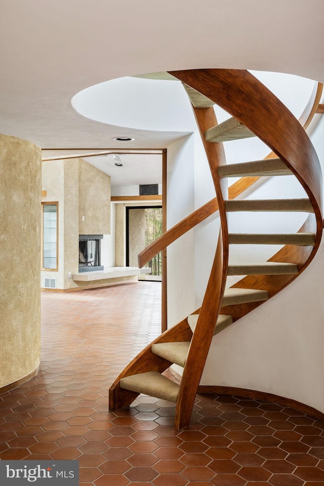 390 S Bryn Mawr Ave, Bryn Mawr, PA 19010 - stairs with a fireplace, tile patterned flooring, and visible vents