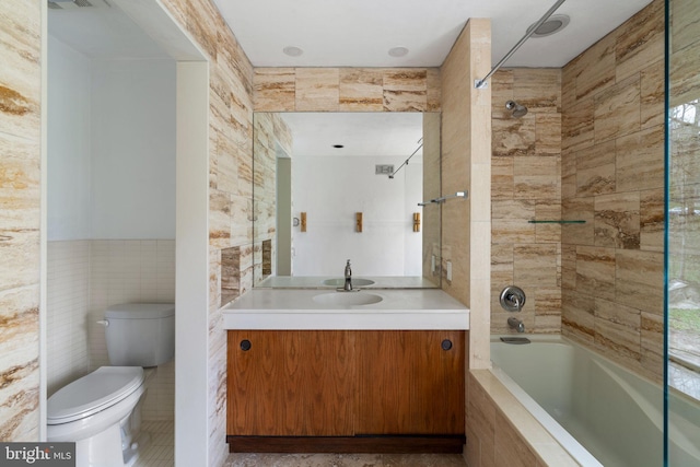 390 S Bryn Mawr Ave, Bryn Mawr, PA 19010 - bathroom featuring toilet, vanity, tile walls, and tiled shower / bath combo