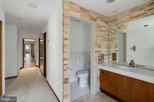 390 S Bryn Mawr Ave, Bryn Mawr, PA 19010 - bathroom featuring vanity, tile walls, and toilet