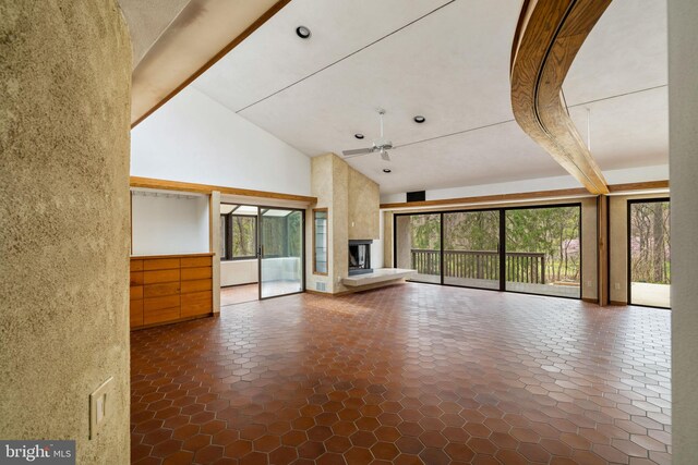 390 S Bryn Mawr Ave, Bryn Mawr, PA 19010 - unfurnished living room with a large fireplace, ceiling fan, and high vaulted ceiling