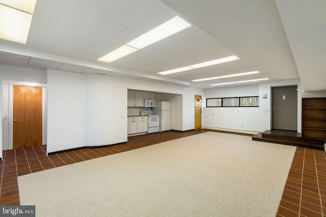 390 S Bryn Mawr Ave, Bryn Mawr, PA 19010 - basement with baseboard heating, freestanding refrigerator, and baseboards