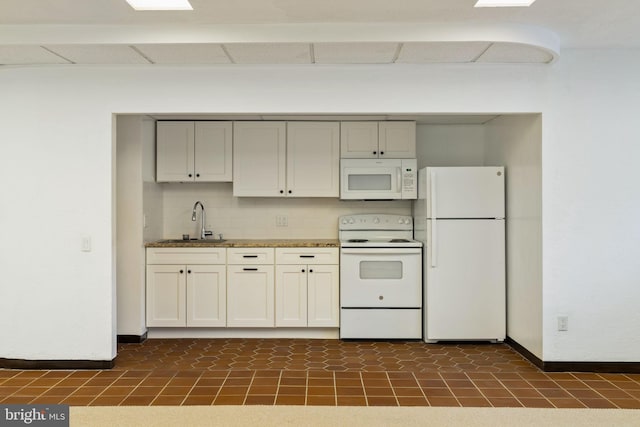 390 S Bryn Mawr Ave, Bryn Mawr, PA 19010 - kitchen with white appliances, baseboards, a sink, and a drop ceiling