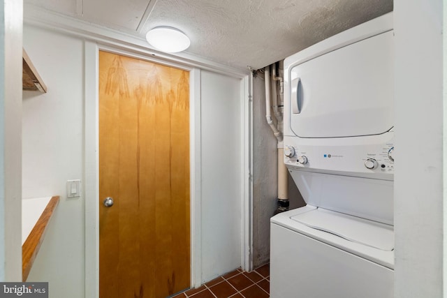 390 S Bryn Mawr Ave, Bryn Mawr, PA 19010 - clothes washing area with stacked washer / dryer, laundry area, dark tile patterned flooring, and a textured ceiling