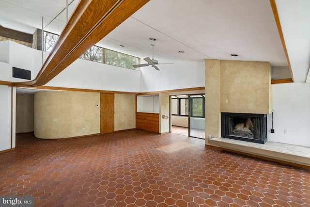 390 S Bryn Mawr Ave, Bryn Mawr, PA 19010 - unfurnished living room featuring a large fireplace, a ceiling fan, and a high ceiling